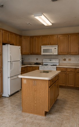 Kitchen before: honey oak cabinets, laminate counters and white appliances